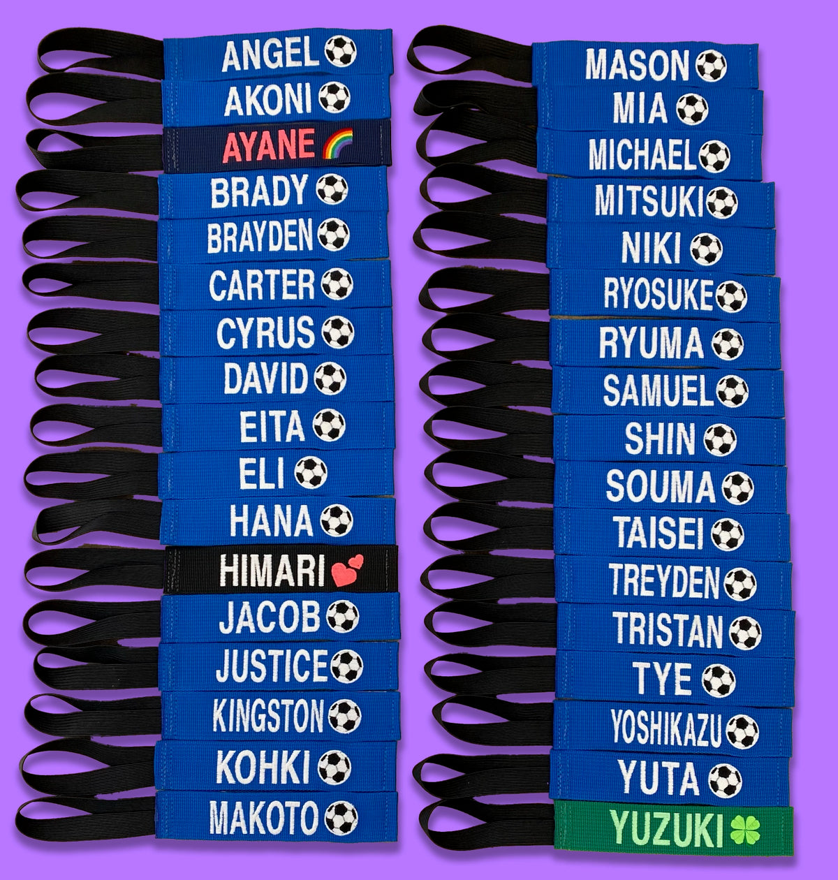 Two columns of blue embroidered bag tags with player names and soccer balls