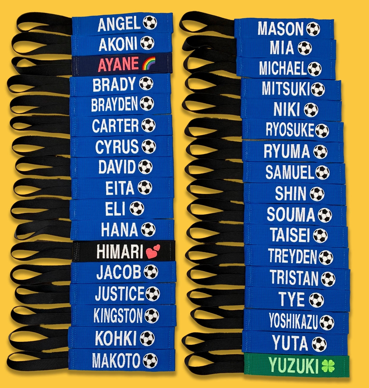 Two columns of blue embroidered bag tags with player names and soccer balls