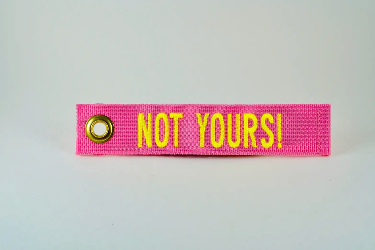 NOT YOURS! embroidered grommet luggage tag with cable tie attachment